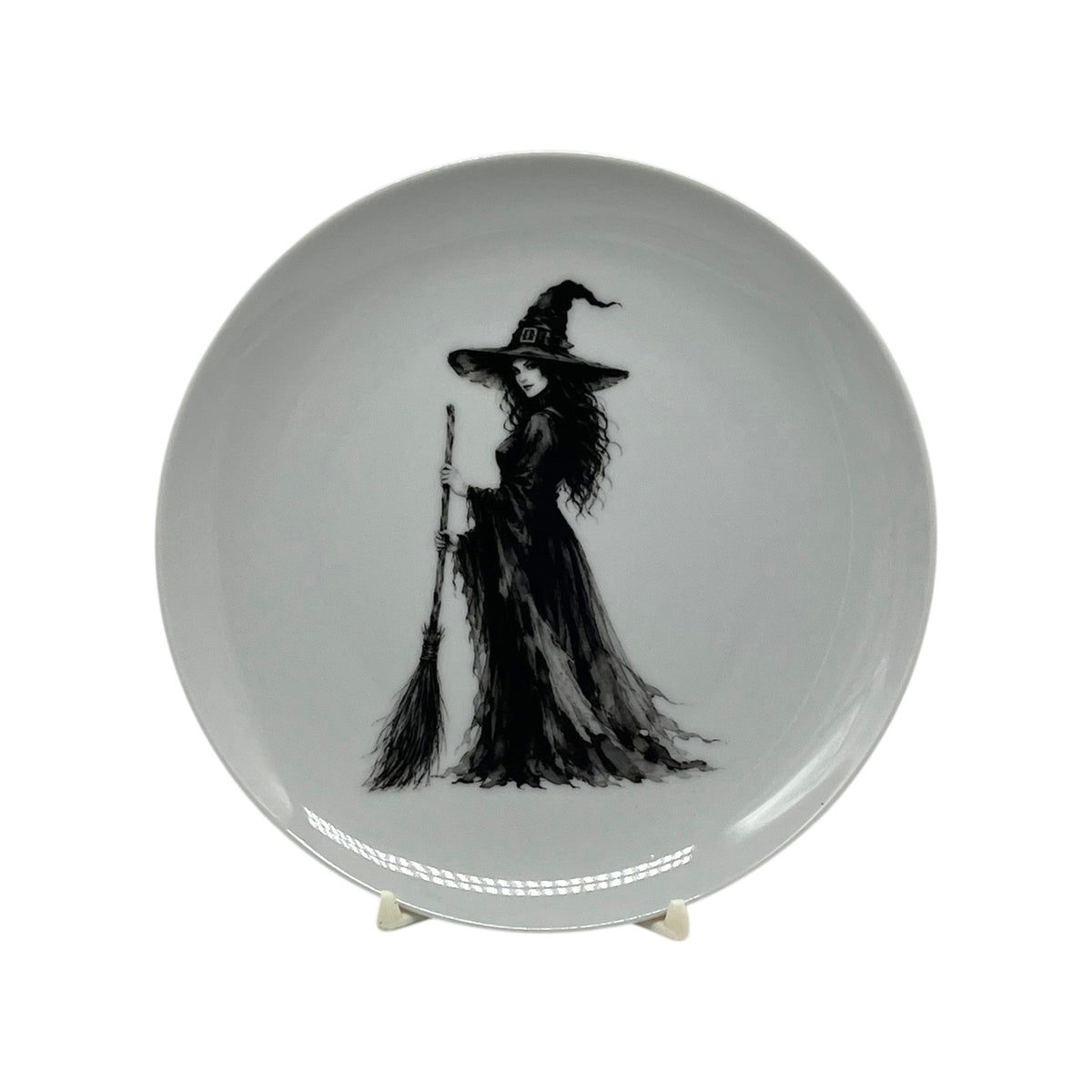 Midnight Witch 6.25 inch Halloween coupe plate featuring black-and-white witch artwork with pointed hat, flowing gown and broom