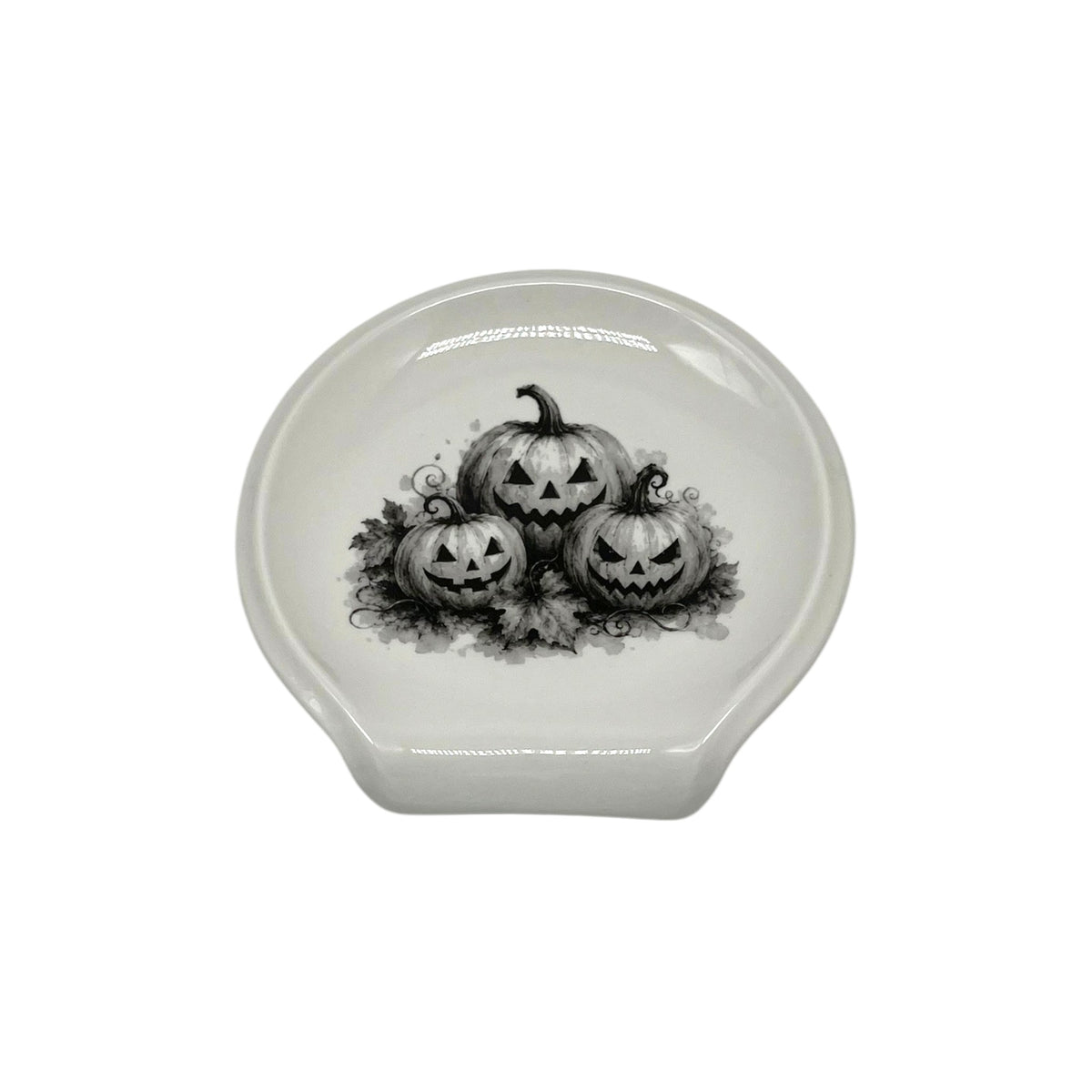 Jack-O’-Lantern Trio Halloween spoon rest featuring three black-and-white carved pumpkins with autumn leaves and curling vines